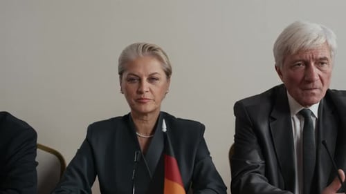International Delegates Seated at Press Conference Table