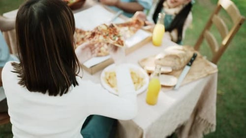 Family Picnic with Pizza in Garden