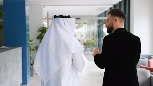 Arab Businessman Showing Modern Office to Western Business Partner