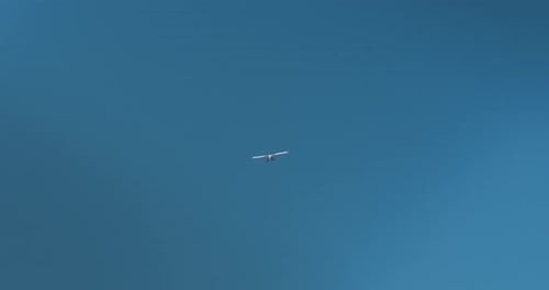 Small Aircraft Flying in a Blue Sky