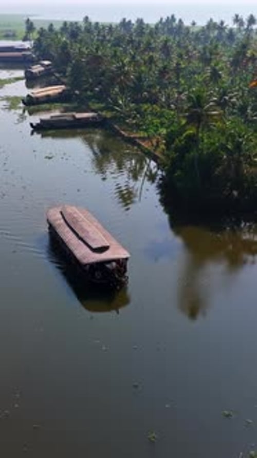 Drone vertical filmé en rotation depuis une péniche dans les backwaters du Kerala, en Inde