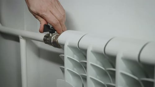 Closeup of a Heating Radiator and Faucet