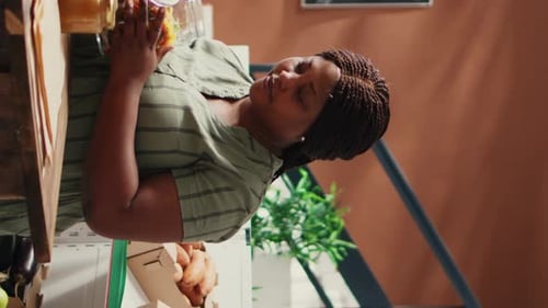 Woman Pours Spiral Pasta into Paper Bag