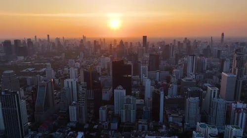 Captivating sunset over a bustling city skyline with shimmering skyscrapers