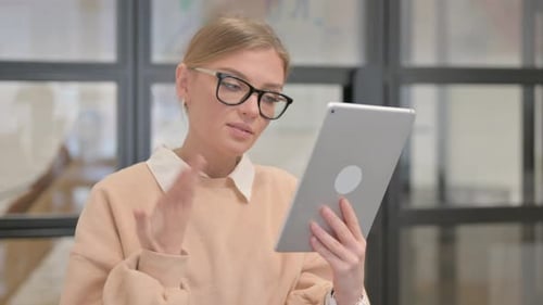 Woman Uses Tablet for Video Call Conversation