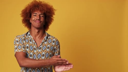 Adult Man Presenting on Orange Background