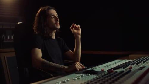 Upset man closing face with hands in modern music recording studio