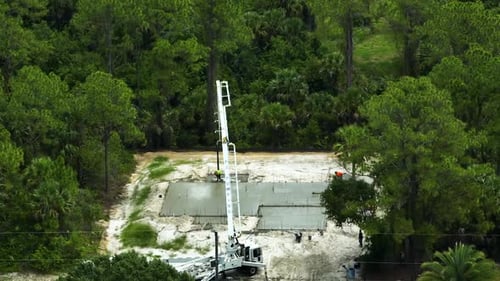 Aerial View of Workers at New House Construction Site Pouring Concrete of Flat Slab Foundation