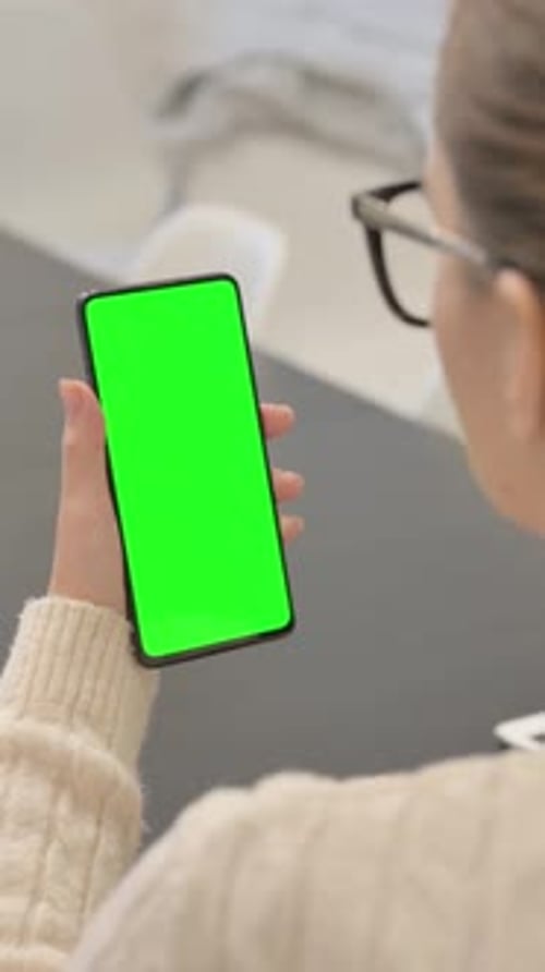 Woman Using Phone with Green Chroma Key Screen