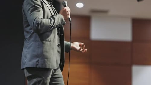 Speaker Presents at Corporate Conference on Stage