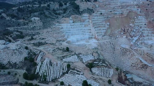 Aerial view of Open-air mining activity in a white marble mine.
