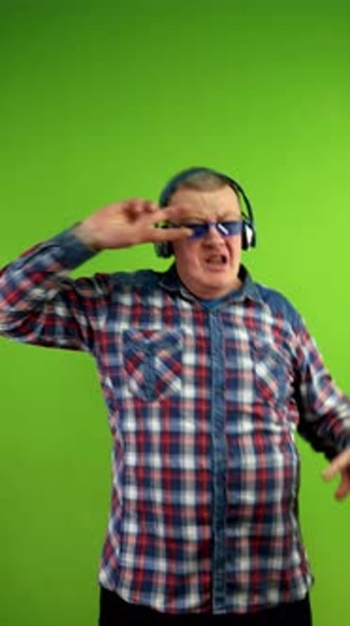 Expressive Man Dancing With Headphones on Green Screen