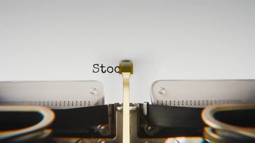 Old mechanical typewriter typing Stock Market in a close-up view.