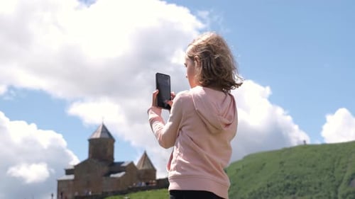 Little Girl Taking Photos of Old Georgian Church