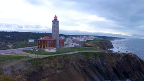 Aerial view of beautiful sunrise and light of the lighthouse.