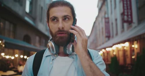 Close Up of Handsome Confident Stylish Man Talking By Cellphone While Walking Around City Streets
