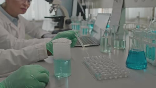 Lab Technician Conducts Experiment in a Modern Laboratory