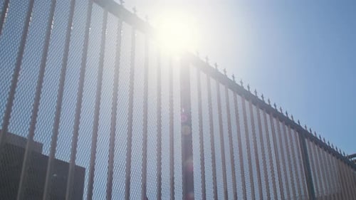 Modern City Fence on Bright Sunlight Bottom View. Metal Forging Barrier Against