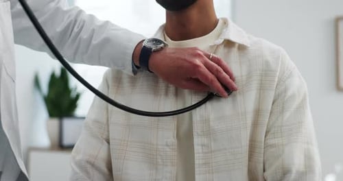 Doctor Examines Patient with Stethoscope in Hospital Room