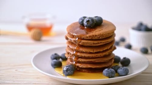 Delicious Stack of Pancakes with Blueberries and Syrup