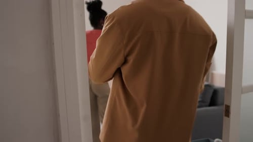 Couple Unpacking Moving Boxes in New Home