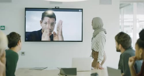 Business Meeting With Remote Colleague in Office