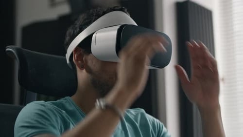 Young Adult Using Virtual Reality Headset Indoors
