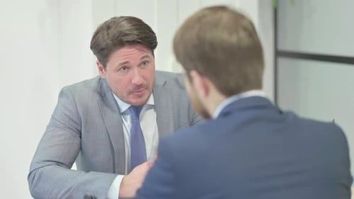Tense Businessman in Argument with Worker