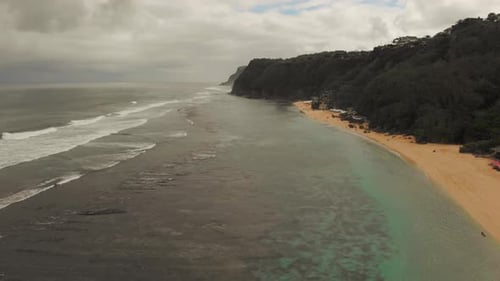 Aerial View of Ocean with Turquoise Lagoon Black Sandy Beach and Mountains Covered Green Plants