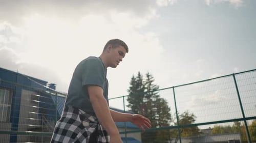 Man Playing Volleyball Outside in Sunlight