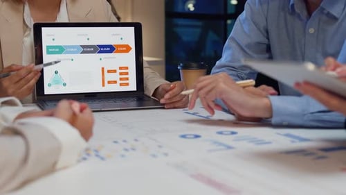 Closeup businesspeople meeting plan analysis statistics brainstorm at office night.