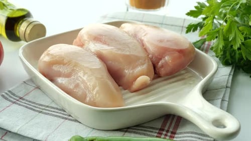 Top View of Raw Breast Chicken Meat and Vegetables on Table