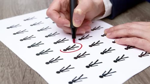 People statistics concept. The woman's hands mark the person depicted on the paper.