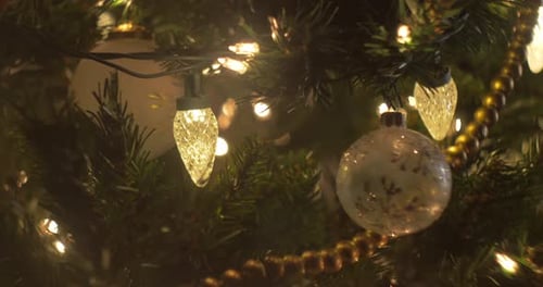 Christmas tree ornaments and lights in a close up, bokeh, slider move, cute decorations