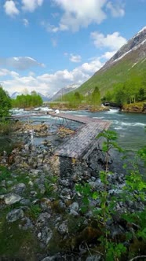Scenic Mountain River Landscape with Wooden Bridge