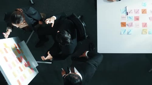 Business Team Brainstorming at Table from Above View