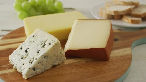 Delicious Cheese and Grapes on Cutting Board