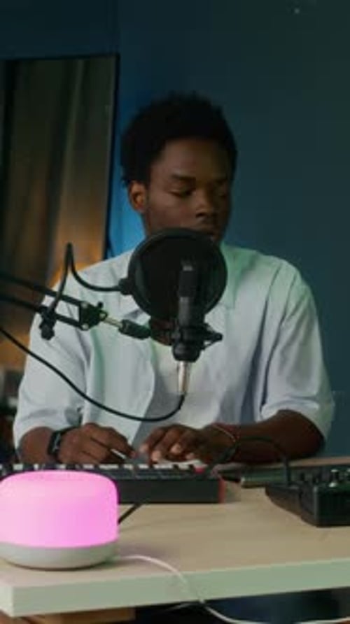 Male Songwriter Using Music Equipment at Home Studio
