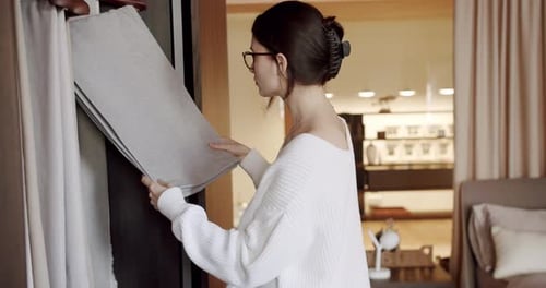 Young Woman Chooses Curtains in the Store