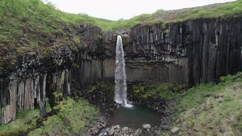 Aerial shot of the Svartifoss waterfall during summer in the Vatnajökull National Park along the Rin