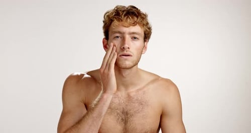 Face, skincare and man with cosmetics, beauty and dermatology on studio background