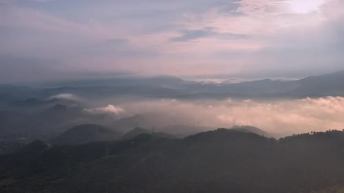 Aerial view morning scenery Mist flowing over the high mountains.