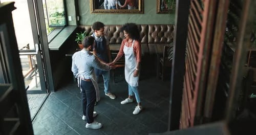 Team, hands together and people in restaurant for hospitality, startup collaboration