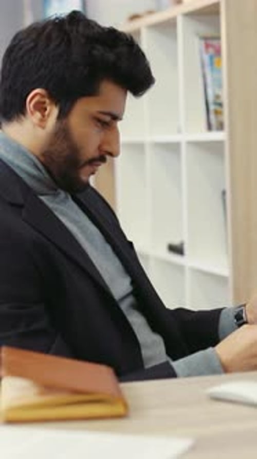 A Suited Man Reflects at His Desk Symbolizing Time and Decisions