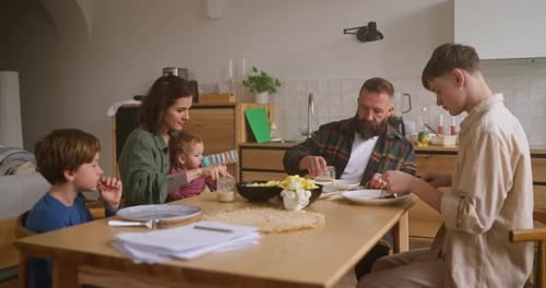 Family of Four Eating Lunch at Home Together