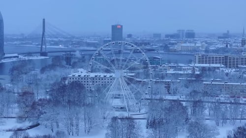 Winter Cityscape with Snow-Covered Ferris Wheel