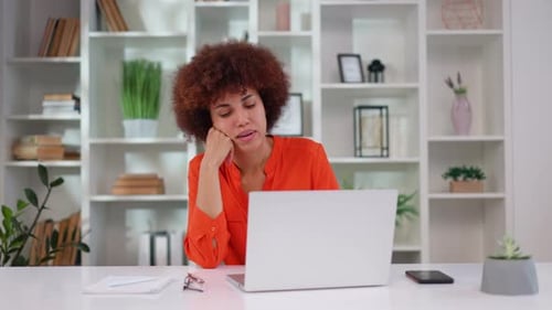 Tired African American Woman Feeling Sleepy and Bored While Sitting at Office