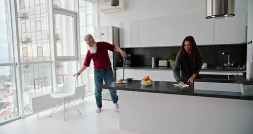 Couple Cleaning Modern Apartment Together