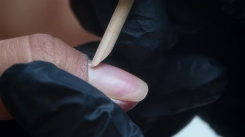 Cuticle Care with Wooden Stick During Nail Treatment