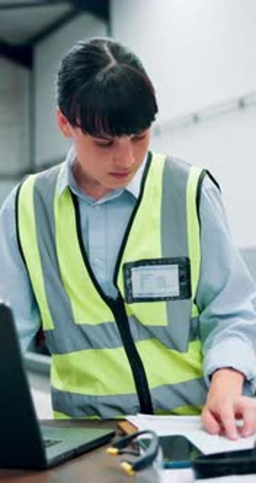 Woman, engineer and paperwork with laptop at warehouse for checklist, admin and report writing